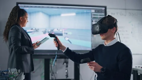 Teacher Supervising While Student Uses VR For Industrial Design Stockbeeldmateriaal 182943051