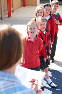 Teacher Taking School Register In Playground Stock Photos