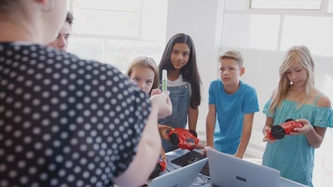 Teacher Talking With Group Of Students In After School Computer Class Learning Stock Footage 111932769