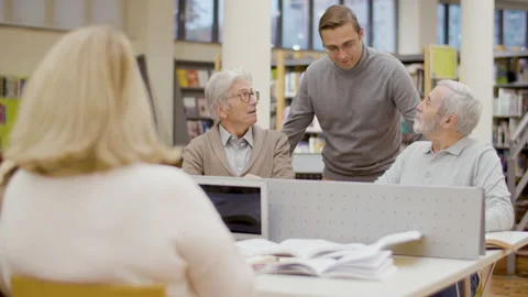 Teacher talking with senior people studying in library Stock-Footage 232623046
