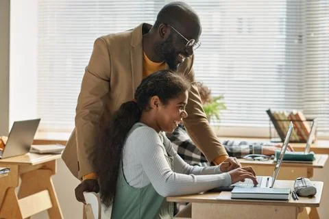 Teacher talking to student at class Stock Photos