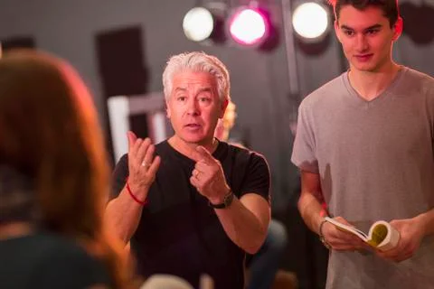 Teacher talking to students in theater class Stock Photos