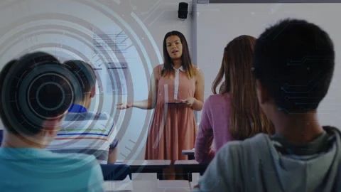 Teacher tapping tablet and gesturing in class, causing HUD and code overlays for Stock Footage 334693918