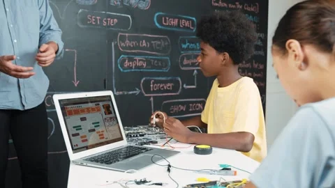 Teacher teach about coding system while student fixing main board. Edification 動画素材 282843862