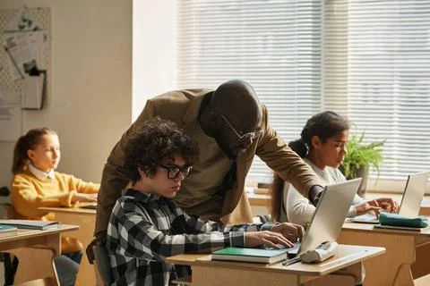 Teacher teaching children to IT technology Stock Photos