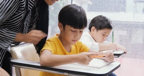 Teacher teaching her student at classroom. Education concept. Stock Footage 111296812