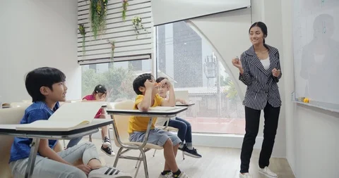 Teacher teaching her student at school. Stock Footage 111406916