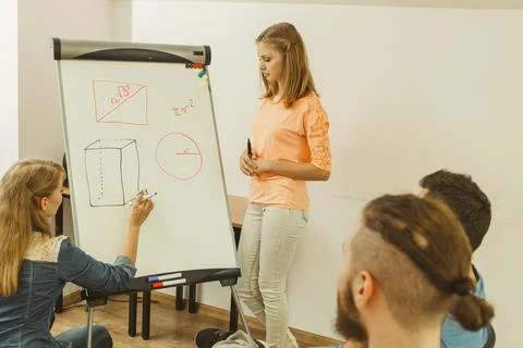 Teacher teaching mathematics to college students Stock Photos