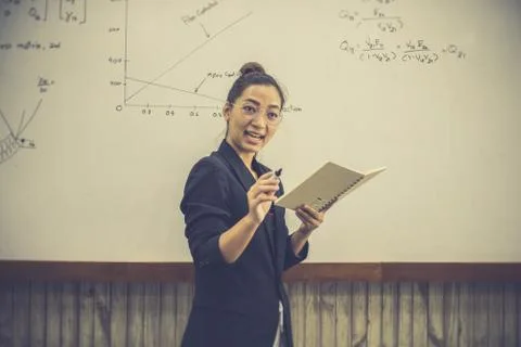 Teacher is teaching physics to students during the new school days after a lo Stock Photos