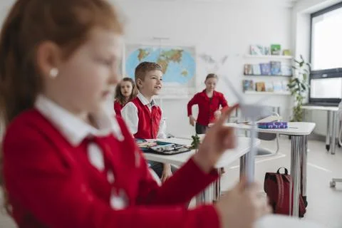 Teacher teaching primary school students about renewable wind energy. Stock Photos