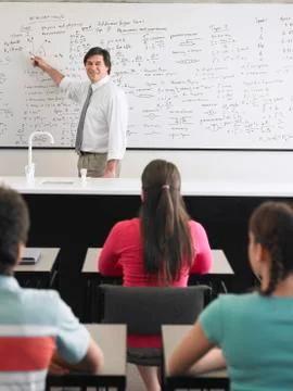 Teacher Teaching To Students In Class Stock Photos