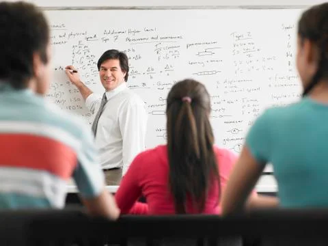 Teacher Teaching To Students In Class Stock Photos
