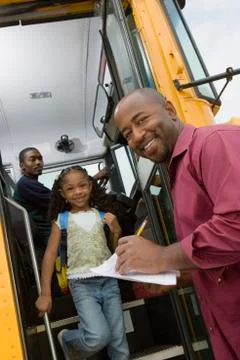 Teacher Unloading Elementary Students From School Bus Stock Photos