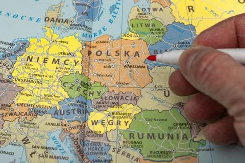 The teacher uses a pointer to show the location of Poland on the map, a pol.. 写真素材