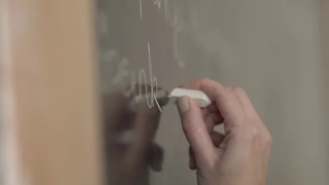 Teacher using a chalk to write on the board, stock video Vidéo 85443302