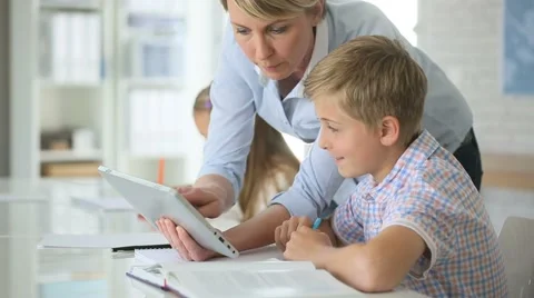 Teacher using digital tablet as educational tool in class Video stock 49748417