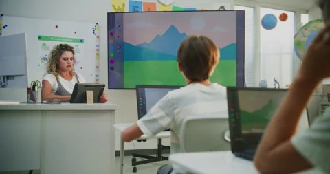 Teacher Using Tablet Computer, Educating Young Students, Showing Digital Process Stock Footage 315472076