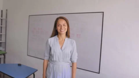 Teacher walking into focus in the classroom. Stock Footage 148964013