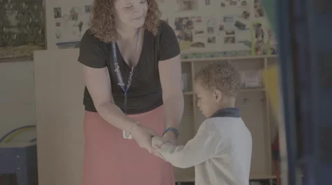Teacher welcoming student Stock Footage 62829759