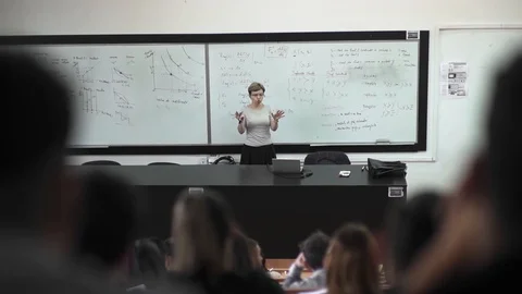Teacher at White Board Explaining Class Room Full Students Stock-Footage 127614769