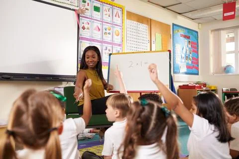 Teacher With Whiteboard In Elementary School Maths Class Stock Photos