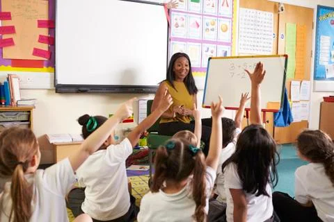Teacher With Whiteboard In Elementary School Maths Class Stock Photos