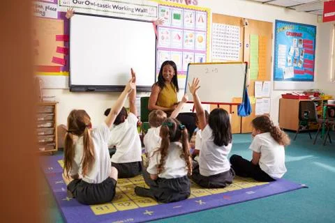 Teacher With Whiteboard In Elementary School Maths Class Stock Photos