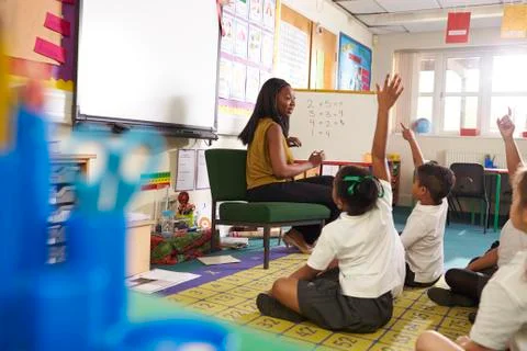 Teacher With Whiteboard In Elementary School Maths Class Stock Photos
