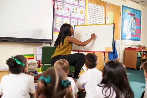 Teacher With Whiteboard In Elementary School Maths Class Stock Photos