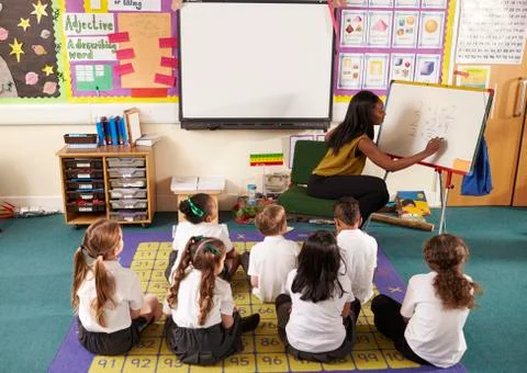 Teacher With Whiteboard In Elementary School Maths Class Stock Photos