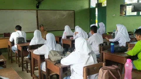 Teacher who is teaching in the classroom Stock Footage 254635797