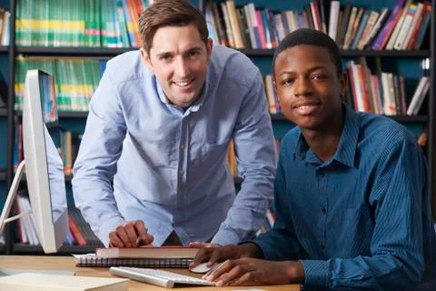 Teacher Working With Pupil At Computer Stock Photos