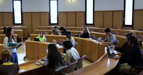 Teacher working with students inside classroom at school university Stock Footage 203728946
