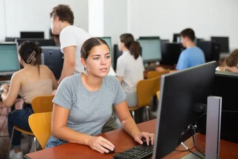 Teacher works at computer in the classroom. Students doing programming Stock Photos