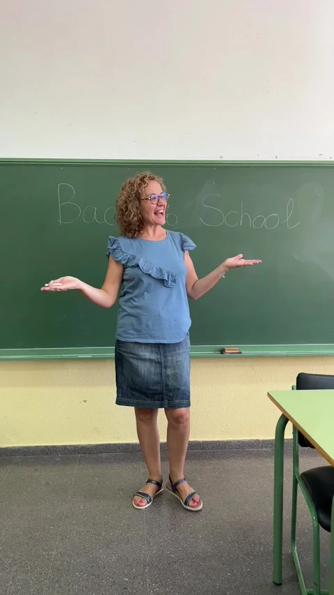 A teacher writes on the blackboard on the first day of the class Stock Footage 248954053