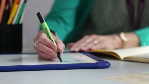 Teacher writes on white board Stock Footage 103327945