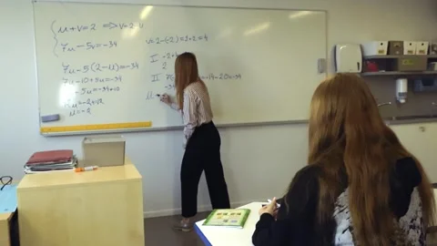 Teacher writing complex math equation on whiteboard Stock Footage 344105729
