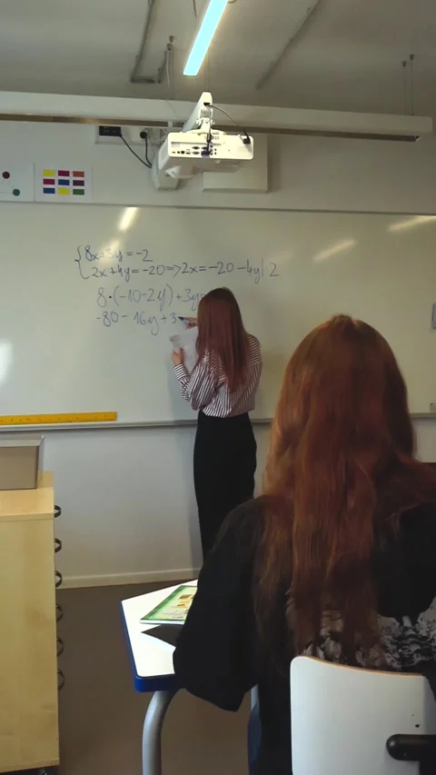 Teacher writing a math equation on a whiteboard Stock Footage 346597949