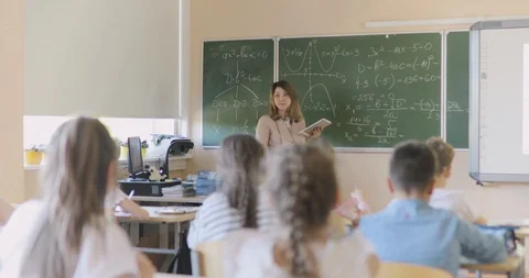 Teacher Writing Math Formula on Board During Lesson. Stock-Footage 97340101