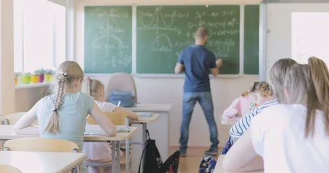 Teacher Writing Math Formula on Board During Lesson Stock-Footage 97340269