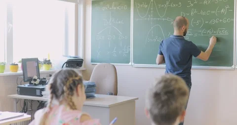Teacher Writing Math Formula on Board During Lesson. Stock Footage 97340312