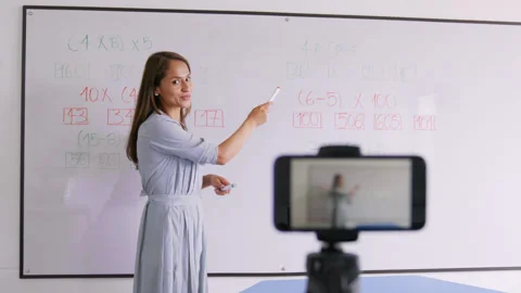 Teacher writing on the whiteboard. Stock Footage 148796916