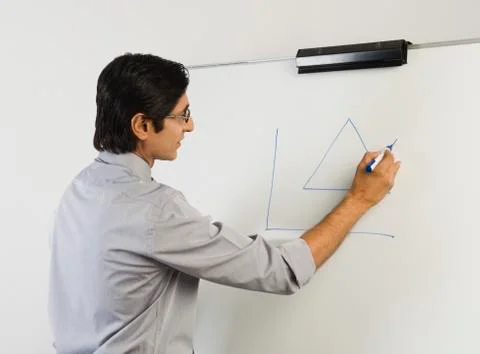 Teacher writing on a whiteboard Fotos Stock