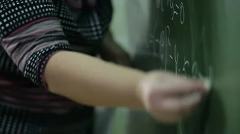 Teacher wrote in chalk on a blackboard Stock Footage