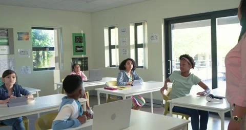 Teacher with youth students asking question in class, central girl raising hand Stock Footage 341665019