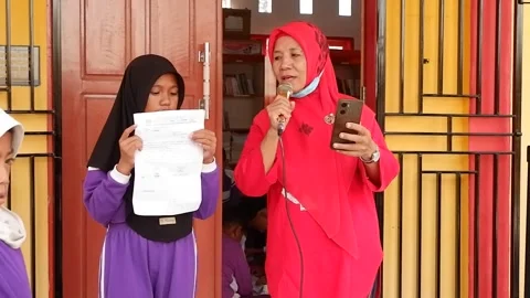 Teachers and students are singing. Central Sulawesi, Indonesia. August 2, 2024 Stock Footage 280877824