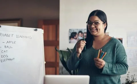 Teachers can do virtually anything they set their mind to. a young woman using a Fotos de archivo