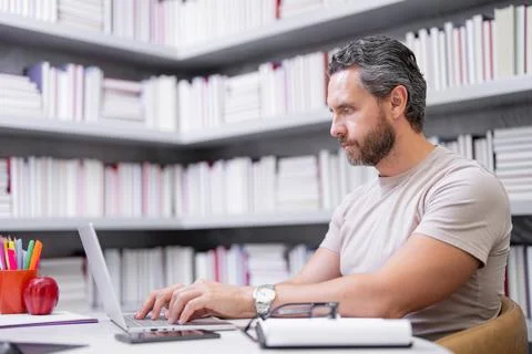 Teachers day. Teacher tutor using laptop in school classroom. Knowledge Stock Photos