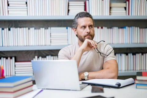 Teachers day. Teacher tutor using laptop in school classroom. Knowledge Stock Photos