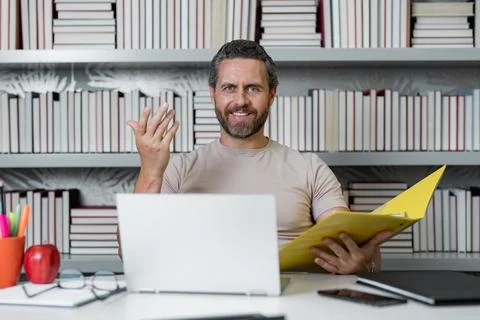 Teachers day. Teacher tutor using laptop in school classroom. Knowledge Stock Photos